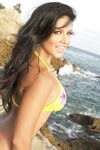 Brunette temptress Sunny Leone exposes herself on the rocky beach