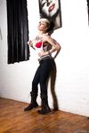 Tattooed model Kleio Valentien takes off clothes and boots to model naked