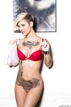 Tattooed model Kleio Valentien takes off clothes and boots to model naked