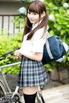 Cutie Japanese schoolgirl in pigtails shows naked ass in no panties upskirt