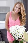 Cute teen Eveline frees her puffy pussy from panties with a daisy in her hair