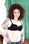 Mature woman with curly hair opens her nice legs to boast of her hairy holes