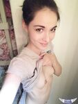 Cute brunette Emily undressing to take self shots of her bare tits and hot ass