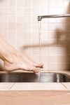 Chilean solo girl runs water from kitchen sink faucet over her natural pussy