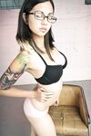 Glasses clad Holly D with big tits drops dress & sheer panties to pose naked