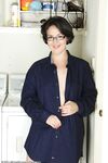 Cute housewife Carlita Johnson disrobes in the laundry room to pose in socks