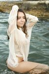 Cute brunette Danniela shows her pretty tits and flaunts her bush in the sea