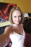 Middle-aged beauty removes her lingerie to set her perky boobs free
