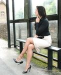 Fully clothed woman Donna slips off her black heels while waiting for a bus