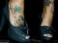 Enticing MILF Claire Dames flaunts her cleavage and inked feet fully clothed