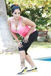 Latina MILF pornstar Kiara Mia revealing knockers while working out by pool