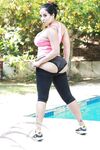 Latina MILF pornstar Kiara Mia revealing knockers while working out by pool