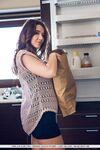 Petite brunette Sybil A poses her naked teen body on kitchen counter in socks