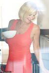 Mature blonde Molly MILF sets her large boobs free of red dress in solo action