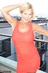 Mature blonde Molly MILF sets her large boobs free of red dress in solo action