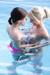 Pretty girls Anneli & Caprice kissing and touching perky wet tits in the pool