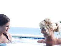 Pretty girls Anneli & Caprice kissing and touching perky wet tits in the pool