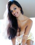 Sexy Indian girl uncovers round boobs as she slips off satin lingerie