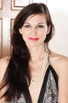 Slim female over 30 wiggles free of her dress and panties to pose nude