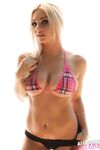 Hot blonde chick takes off her bikini top and hides her tits with her hands