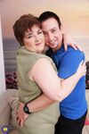 Sexy mature BBW bares her great big tits for her young boy toy to suck on