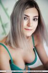 Sweet teen Eva Elfie doffs a bra and panty set to model naked on her bed