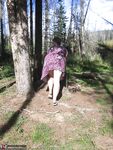 Fat granny Girdle Goddess loses her purple outfit in the woods and poses nude