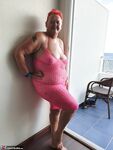 Fat nan with short red hair finger spreads her pussy on oceanside balcony