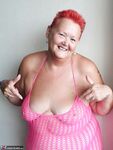 Fat nan with short red hair finger spreads her pussy on oceanside balcony