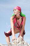 European teen Firebird A posing barefoot on rocky cliffs in revealing outfit