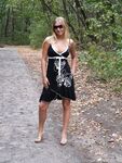 Young blonde girl gets totally naked on dirt path leading to the water