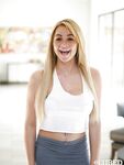 Young blonde female Skyla Novea letting large natural boobs loose from bra