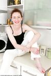 Skinny mature lady Scarlet Louise does a striptease in her kitchen