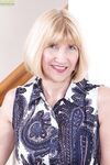 Blonde granny Bossy Ryder stretches open her wet pussy after disrobing