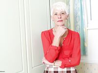 Over 70 Bristish granny takes off her clothes and lingerie striptease style