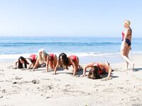 Hot beach babes in swimsuits & bare feet exercising on knees showing sexy ass