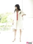 Clothed Japanese model Yuka Yamada shows her bare legs in a skirt
