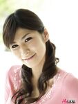 Clothed Japanese model Yuka Yamada shows her bare legs in a skirt