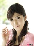 Clothed Japanese model Yuka Yamada shows her bare legs in a skirt
