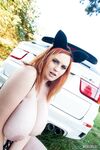 Thick redhead Alexsis Faye releases her huge tits from Catwoman outfit in boot