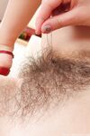 Cute amateur Nessy reveals her hairy pussy and rubs it up close