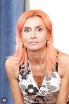 Skinny mature with orange hair Philana reveals her small tits & toys her twat
