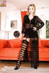 Hot blonde Jana removing sexy stocking and sheer clothing on sofa