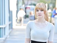 Cute young blonde flashes her big boobs and strolls naked down the street