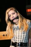 Cute blonde girl struggles against gag and ropes with her clothes still on