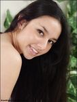 Latina amateur with long hair spreads her full bush while naked on bed