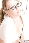 Sexy schoolgirl Brook Little in pigtails & glasses undressing to show big tits