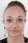 Pierced and tattooed amateur Petra stands naked after removing her clothes