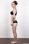 Pierced and tattooed amateur Petra stands naked after removing her clothes