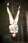 Bella Rossi is tied down and suspended in a variety of hardcore bondage poses